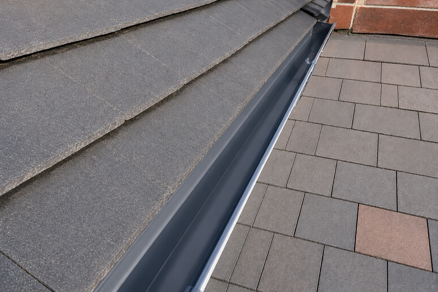 After gutter cleaning — same gutters fully cleared to the channel with downpipes running freely